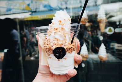 Hand holding ice cream cone