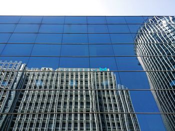 Low angle view of skyscraper against blue sky