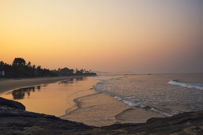 Scenic view of beach against sky during sunset