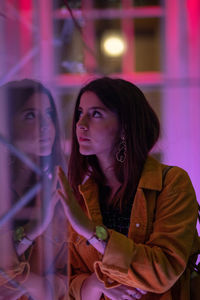 Reflection of young woman on glass