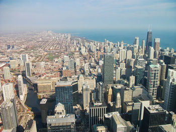 High angle view of modern buildings in city against sky