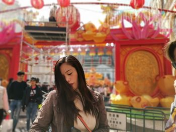 Portrait of young woman in store for sale in market