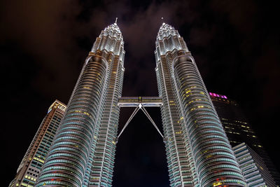 Low angle view of illuminated building against sky at night