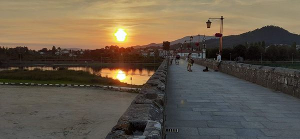 Scenic view of river against sky during sunset