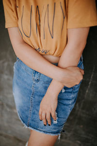 Midsection of woman standing indoors