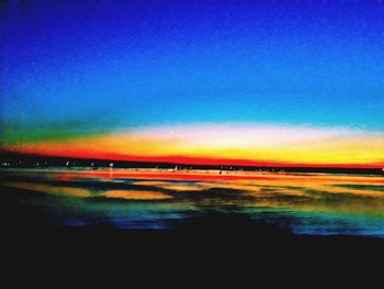 Scenic view of lake against sky at night