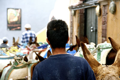 Rear view of people sitting in city