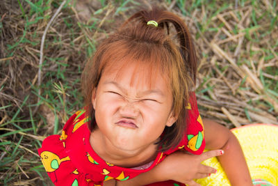 Portrait of cute girl lying on land