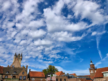 Low angle view of buildings in town against sky