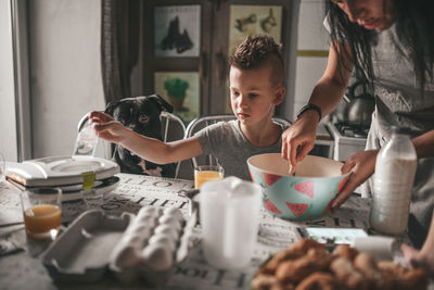 Midsection of woman having food at table