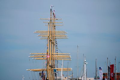 Low angle view of sailboat against blue sky