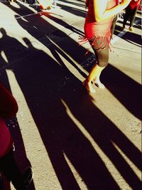 Shadow of people walking on road