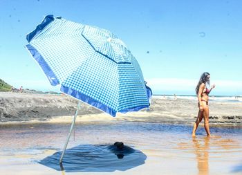 Woman wearing bikini walking in sea