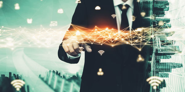 Digital composite image of hand holding illuminated lighting equipment at night