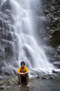 Man surfing in waterfall