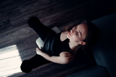 High angle view of woman sitting on floor