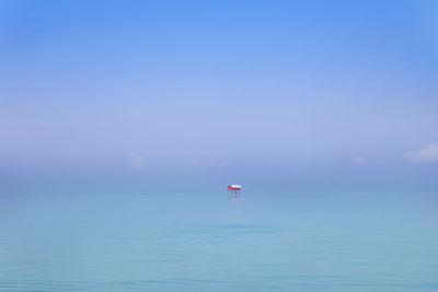 Scenic view of sea against blue sky