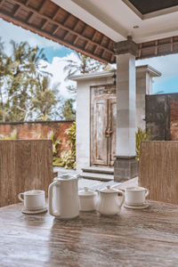 Coffee cup on table by window in building