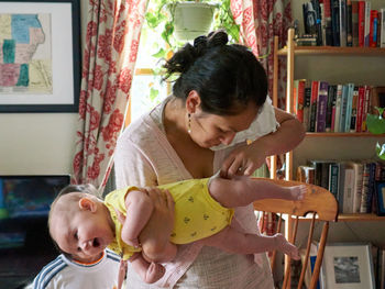 Full length of mother and daughter at home