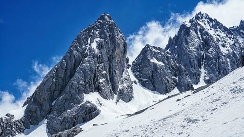 Scenic view of mountains against cloudy sky