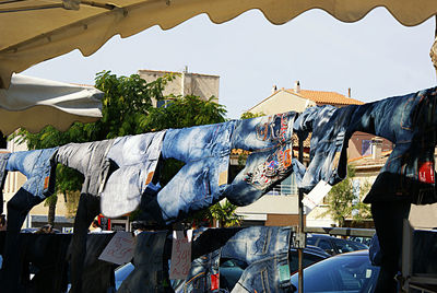 Clothes drying on market for sale in city