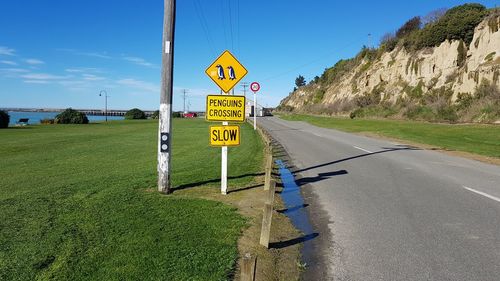 Road sign against sky