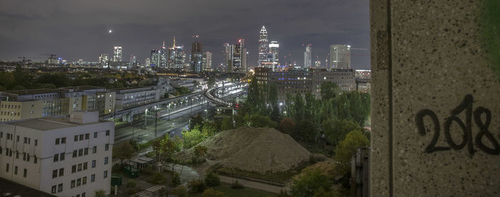 High angle view of road amidst buildings in city at night