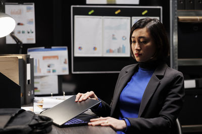 Businesswoman using laptop at office