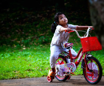 Little girl sitting on her bike.