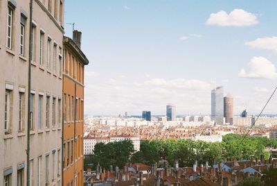 Panoramic view of buildings in city against sky