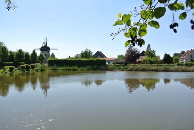 Scenic view of lake by building against sky