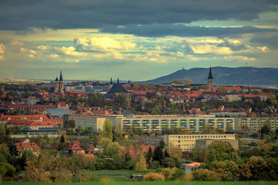 Buildings in town against sky during sunset