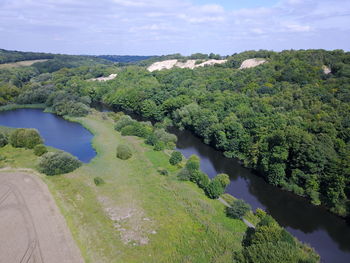 High angle view of river amidst trees against sky