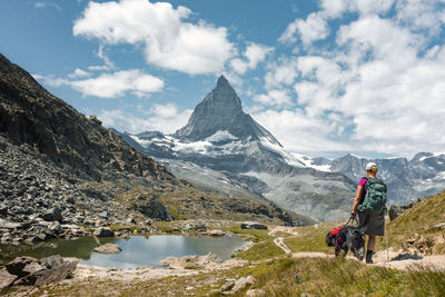 Rear view of man on mountains against sky