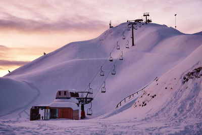 Snow covered mountains against sky during sunset