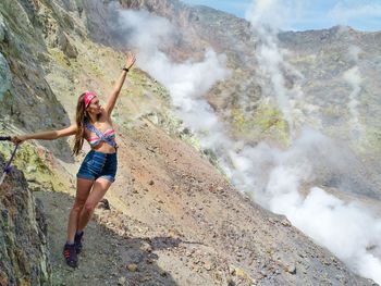 Woman standing on volcano