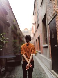 Woman standing on narrow footpath