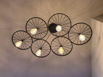 Low angle view of illuminated pendant lights hanging from ceiling