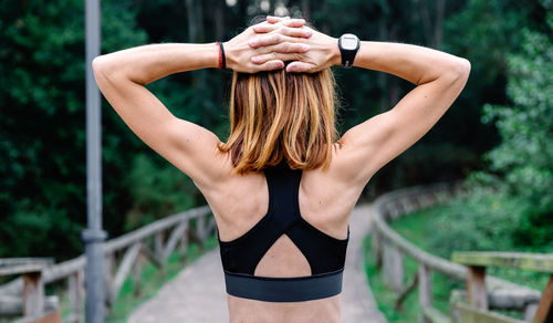 Full length rear view of woman standing in railing