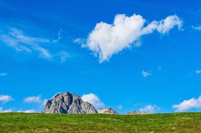 Scenic view of land against blue sky