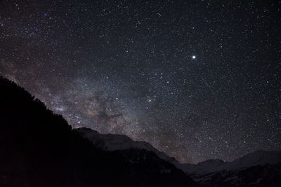 Scenic view of mountains against sky at night