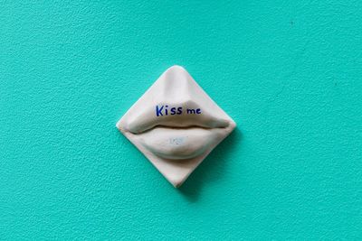 High angle view of heart shape made on green leaf