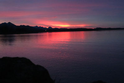 Scenic view of lake against romantic sky at sunset