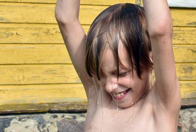 Cute shirtless boy bathing