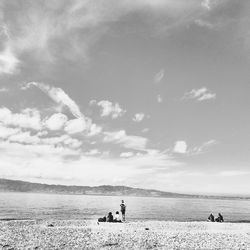 People on beach against sky