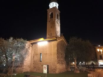 Illuminated building against sky at night