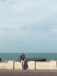 Woman on beach against sky