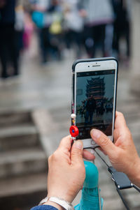 Taking photo with mobile, yellow crane tower, traditional chinese tower on sheshan snake hill.