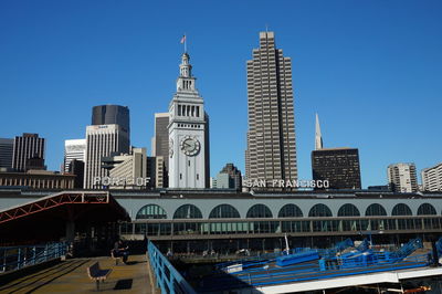 Low angle view of buildings against clear blue sky