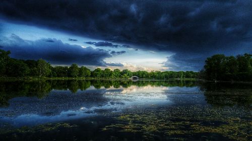 Scenic view of lake against cloudy sky